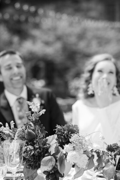 bride and groom smiling at wedding reception