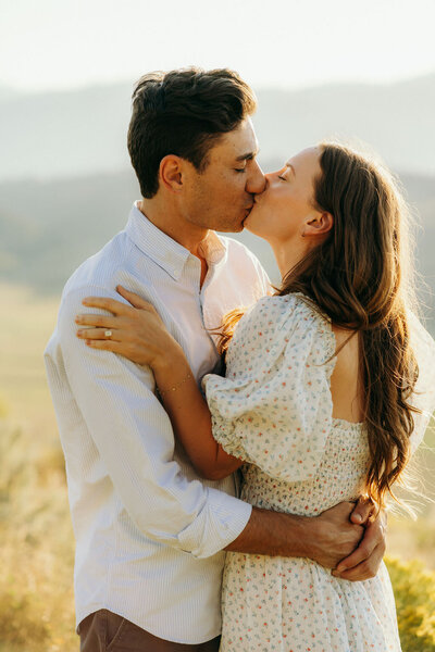 photo of man and woman kissing while standing outside taken by Wedding photographer in Jackson Hole WY