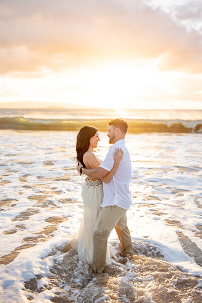 Maui Elopement Photographer captures couples beach portraits while couple pops champagne