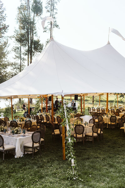 A classic Sperry Tent styled for a wedding, with thoughtfully arranged tables and chairs beneath its graceful, sailcloth canopy.