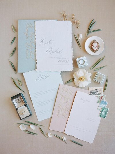 Handmade cotton paper wedding invitations with deckle edges and pastel colors