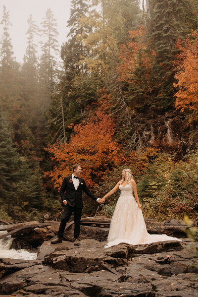Fall wedding photos with couple holding hands
