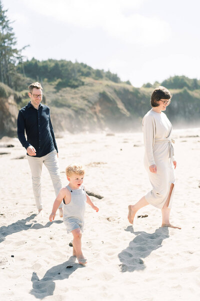 family walks on the beach in lincoln city oregon