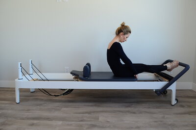 Stretching and strengthening on Pilates reformer