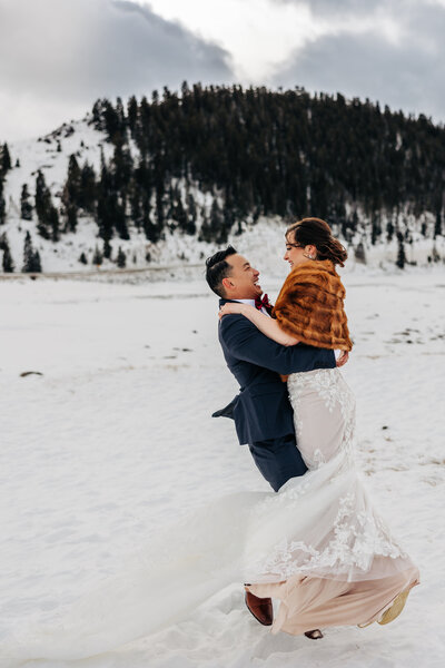 Denver Wedding Photographer captures groom spinning bride in air during bridal portraits