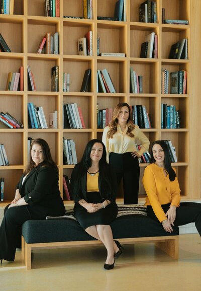 The clinical team of Relationship Experts in front of a book wall representing the amount of knowledge and experience they all have in helping couples in the aftermath of inifdelity with their Affair recovery coaching program offered online in the United States, Canada, and worldwide.