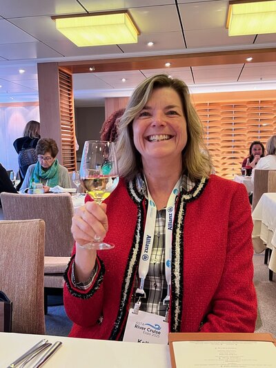Photo of Kelly Smiling with a Glass of Wine