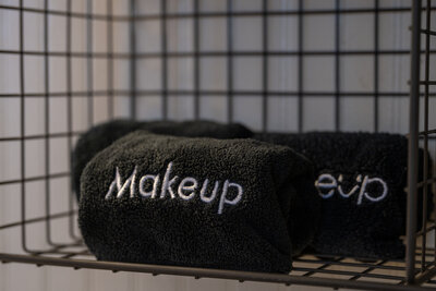Three black makeup towels rolled up
