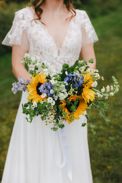 Bride with sunflower bouquet. NH videographer 