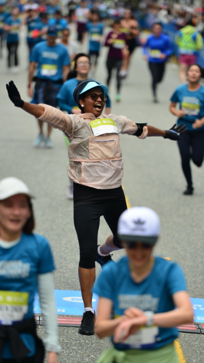 Woman smiling and empowered while finishing a race.