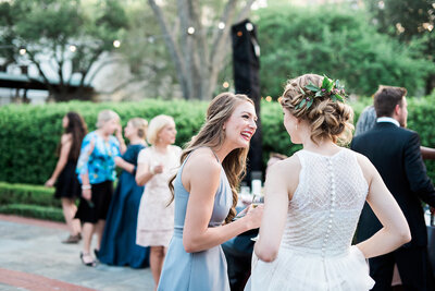 guest laughing with bride at outdoor MN wedding