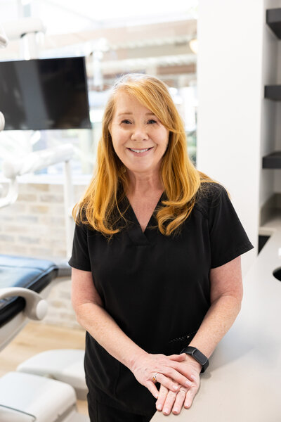 Jerri, a dental assistant at 4Scottsdale Smiles, smiling in her professional attire, assisting with dental procedures and ensuring patient comfort.