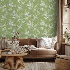 View of a room with a brawn couch decoration with green wallpaper with bird motive