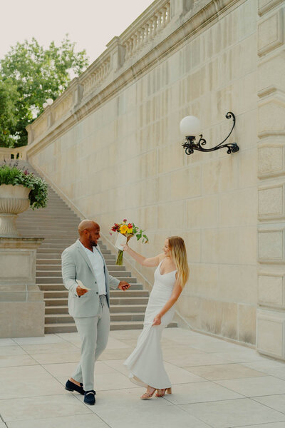 Intimate city hall elopement photos of bride and groom dancing
