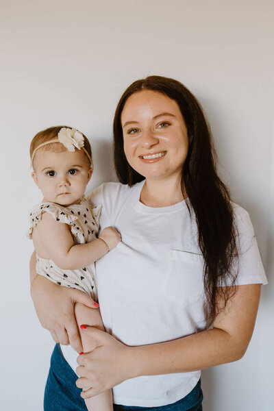 female babysitter holding  a newborn