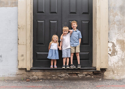 adorable small children that are siblings looking happyin downtown mckinney