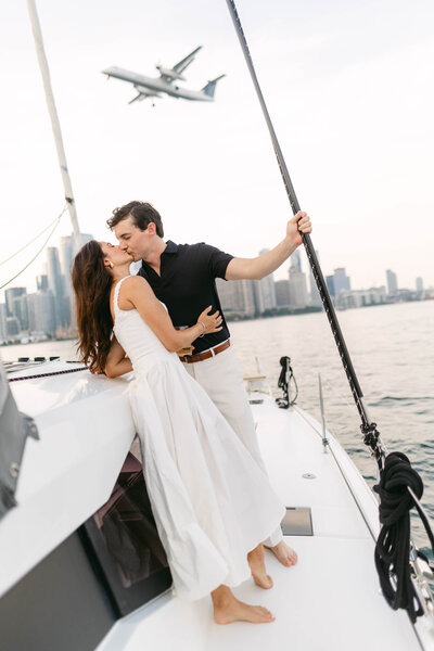 a bride and groom walk hand in half across a golf course at sunset
