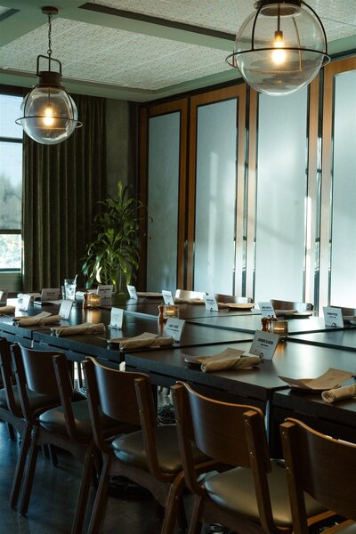 An empty private event space at Culinary Dropout in Dallas, featuring natural light and a clean setup before guests arrive, captured for event photography.

