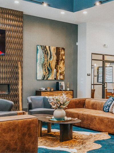 Modern lounge at The Apex at Sky Valley featuring leather seating, abstract artwork, and stylish decor.