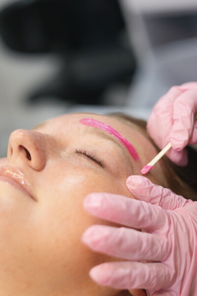 Close-up of wax being applied during eye brow waxing service at Macayla Hopper Esthetics in Hartselle AL