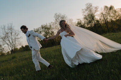 Couple running away for sunset during their wedding reception in Ontario