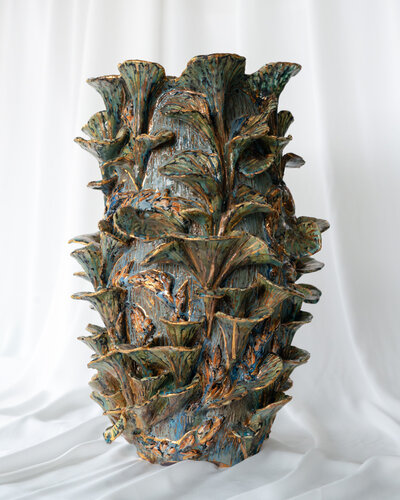 Product photography showcasing a collection of Gerda Satunas' European-inspired ceramic sculptures, highlighting texture and detail