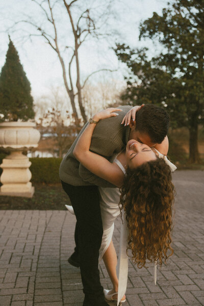 engagement photo couple looking at each other standing and sitting