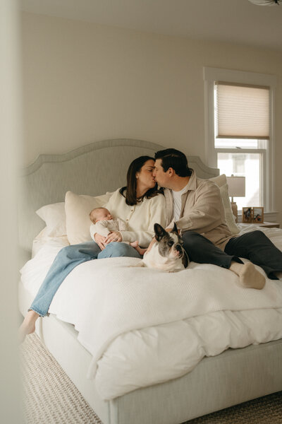 Mother sitting in a grassy field at sunset, surrounded by her three young children during a motherhood session in Peapack, NJ, photographed by Burkat Photography.