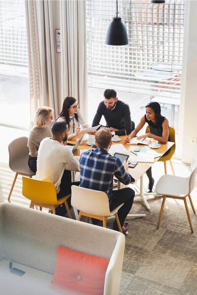 team members sitting at an office table
