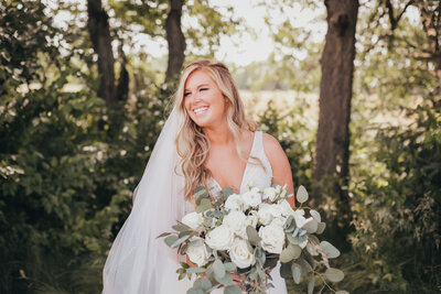 Wedding session of bride  smiling and holding bouquet