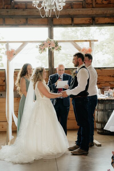 Bride and groom holding hands at their wedding ceremony