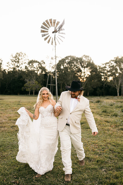 bride and groom popping Champagne