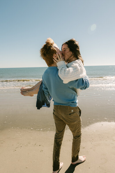 engagement photo of couple running around the beach in florida