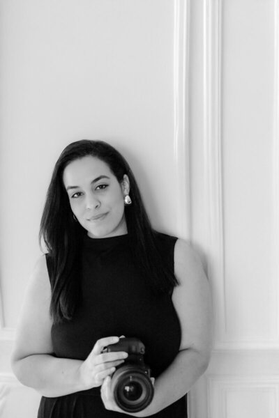 Priscila Del Cristo, Tampa wedding photographer, holding a camera.