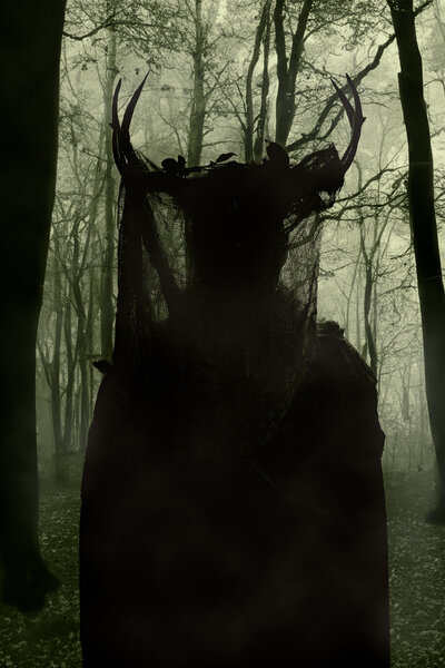 Person dressed in Antler Queen Costume from Yellowjackets show standing in front of digital forest backdrop.