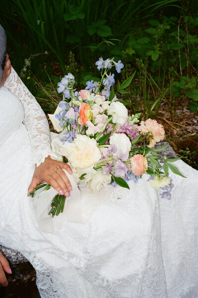 bride holding colorful bouquet of flowers