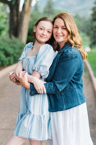 Mother and daughter hug lovingly while posing for Washington DC photographer