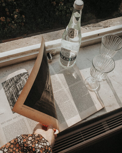 aerial shot of a newspaper and French bottled water