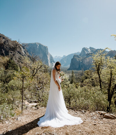 Yosemite bride overlooking valley at sunset after elopement