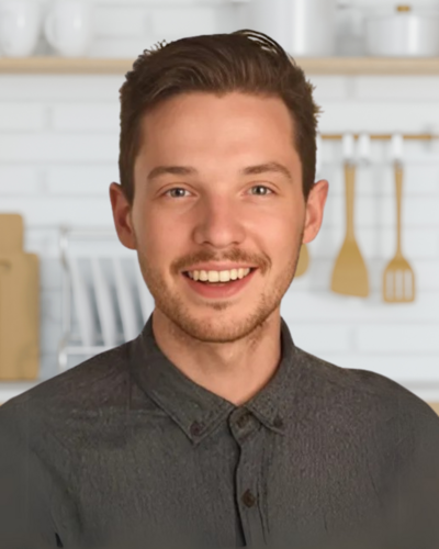 Professional headshot of Michael Wilson, a smiling clinical dietitian, standing in front of a bright kitchen background.