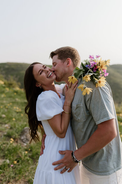 Couple photoshoot in a grass field with flowers. 