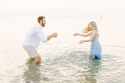 couple playing in the water at warren dunes
