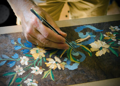 Dave inserts a piece into a french inspired marquetry panel
