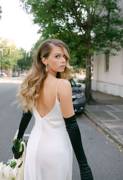 A portrait of the bride looking over her shoulder during a vintage elopement