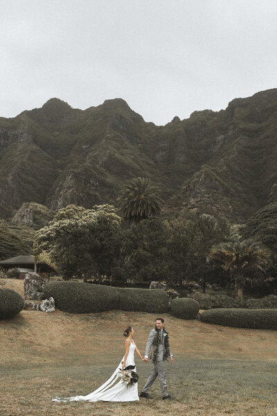Bride and groom in green field