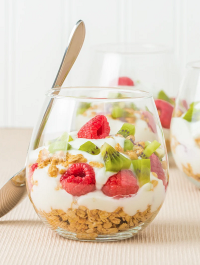 Layered yogurt parfait with yogurt and granola in glass jar