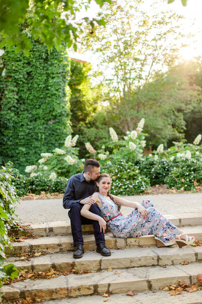 bride and groom-to-be hug on a stair case