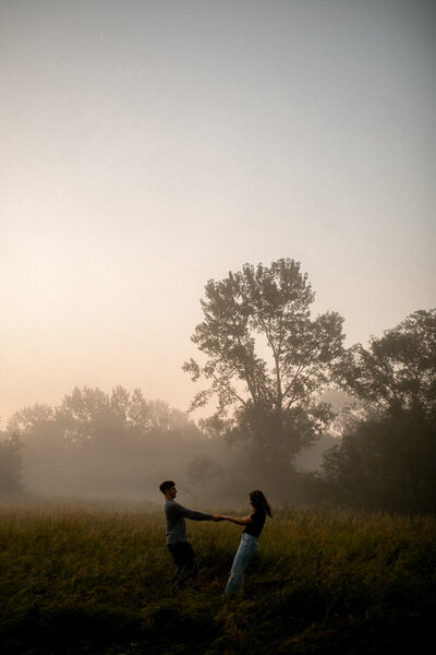 Des Moines Iowa wedding couple where the guy lifted his fiance up and they kiss.