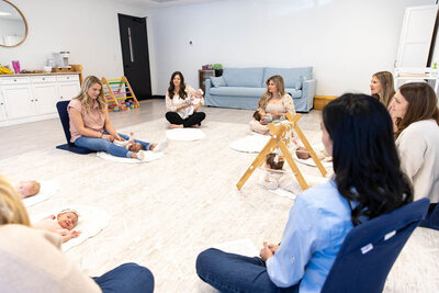Group of women playing on the floor with their babies