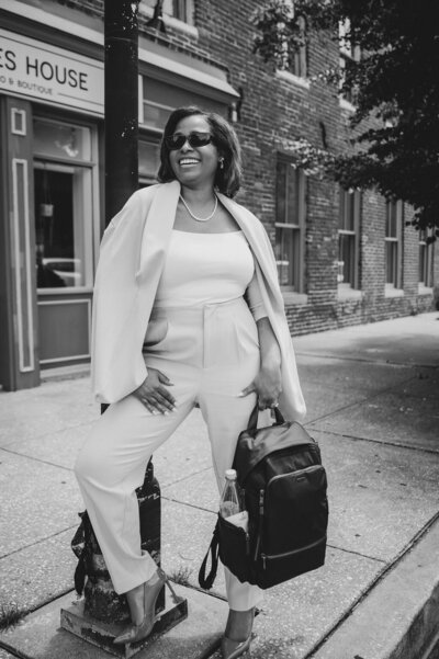 Owner and boss woman posted up on a light pole in the city ready to get work done. Corporate experiences and creative production in DC, MD and LA